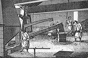 Un dessin du 18e siècle représentant l'intérieur d'un atelier de forge où un ouvrier introduit une barre de fer dans le foyer de la forge, un autre martèle un bloc de fer sur un très gros enclume pour le transformer en barre pendant qu'un aide actionne un levier pour contrôler le rythme du gros marteau hydraulique.