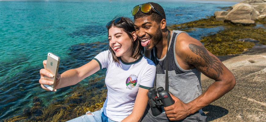 Un couple prend un selfie au bord de l’eau