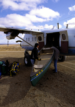 Loading canoes onto a Twin Otter plane