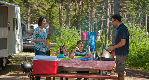 A family cooks lunch at Cavendish Campground, Prince Edward Island National Par