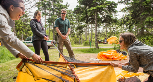 Parks Canada staff member Dave Voit checks in on students setting up their tent during a Learn-to Camp event at Cavendish Campground. Prince Edward Island National Park.