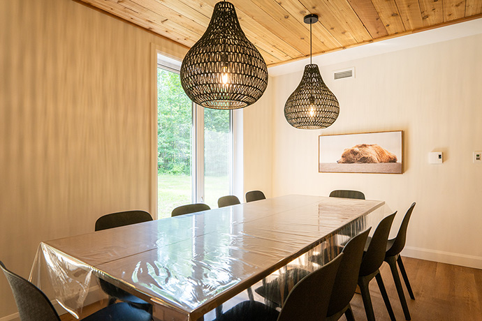 La salle à manger : une grande table rectangle entourée de 10 chaises.