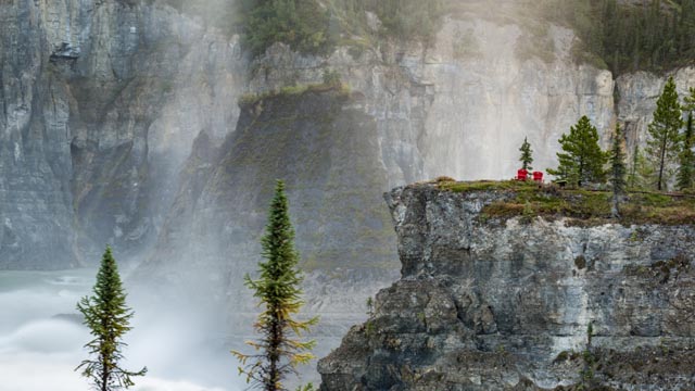 Red chairs at the viewpoint at Náįlįcho (Virginia Falls), in Nahanni National Park Reserve.