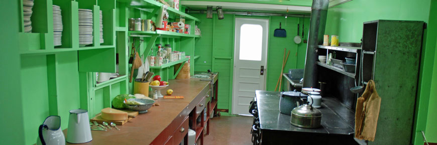 A bright green galley on the S.S. Klondike sternwheeler with a coal-burning stove.